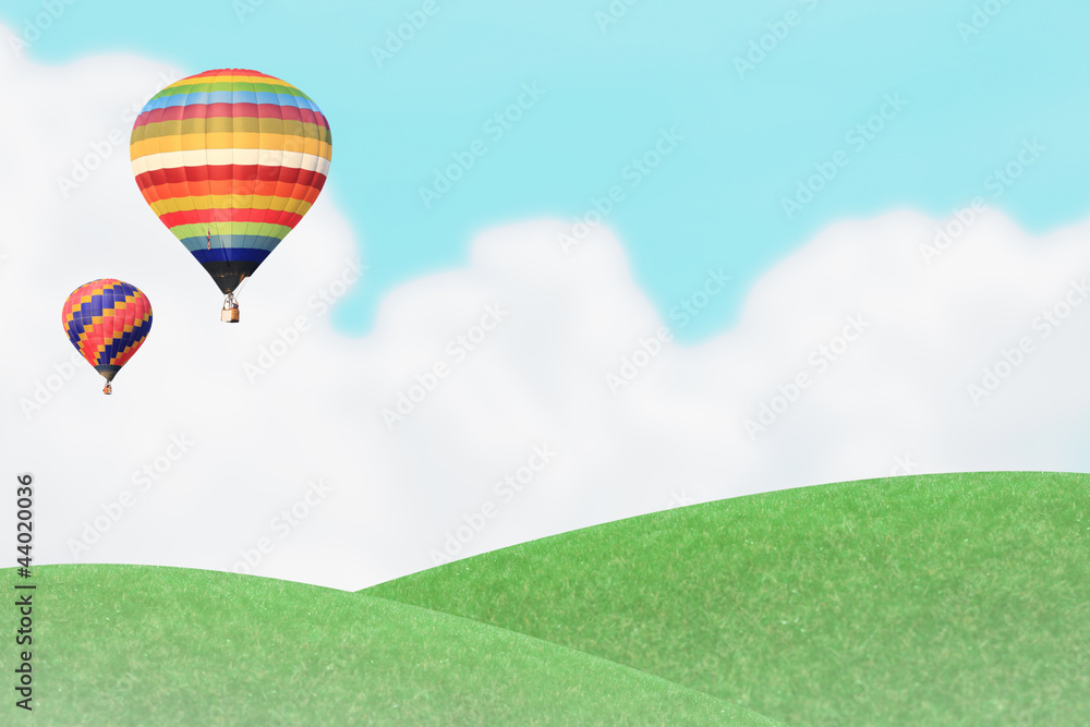 Fototapeta premium Ballons over grass hill.