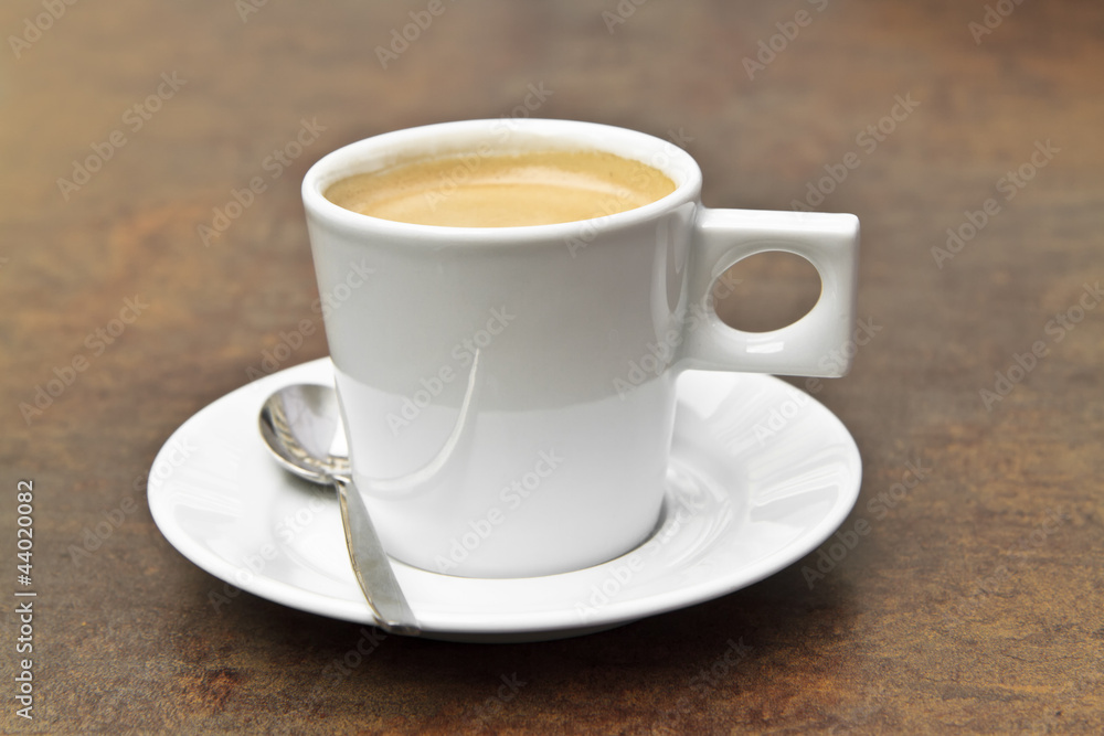 espresso coffee in a white cup on a vintage background
