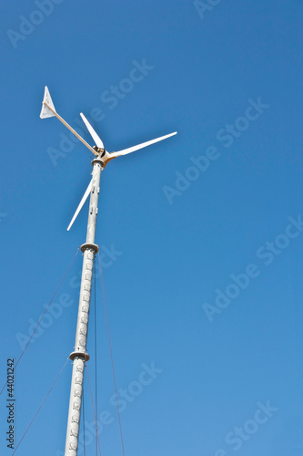 Wind turbine on blue sky background