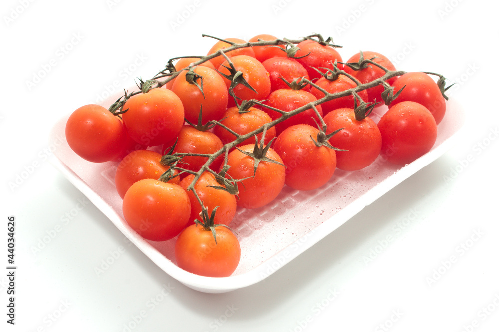 Cherry tomatoes on vine with water drops. Cherry tomatoes on vine with water drops.
