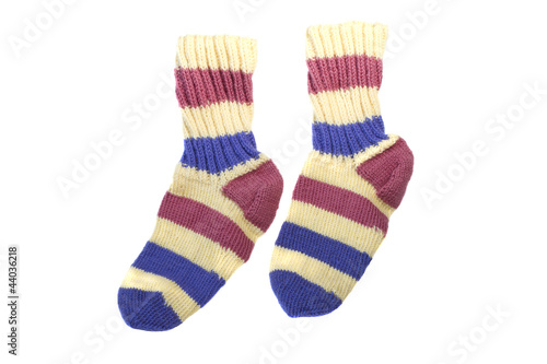 Two multi-colored knitted sock isolated on white