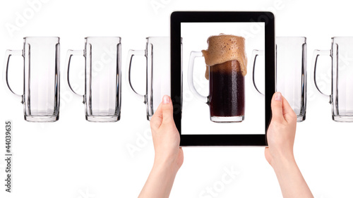 empty and one full beer on tablet computer screen photo