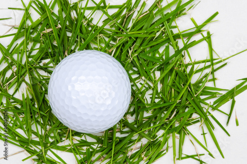 white golf ball top view on grass