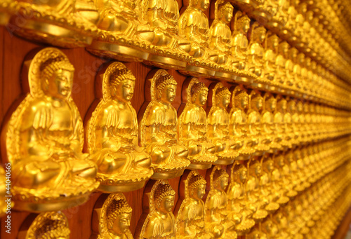 Slika na platnu A thousand of small golden Buddha statue on the wall