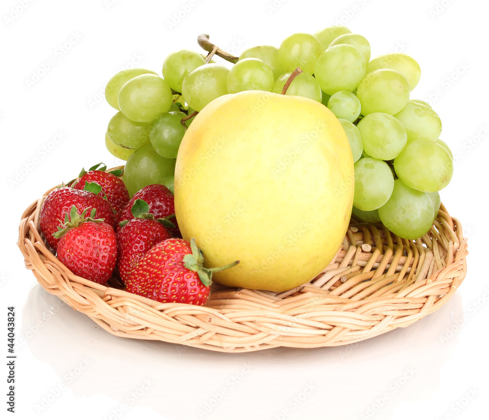 ripe sweet fruits and berries on wicker mat isolated on white