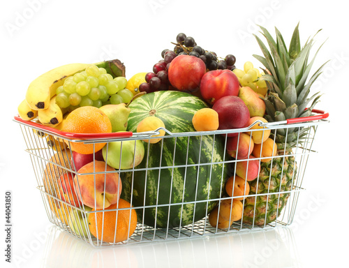Assortment of exotic fruits in metal basket isolated on white