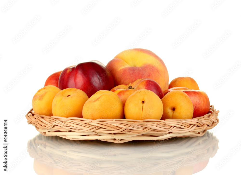 Ripe fruit on wicker mat isolated on white Ripe fruit on wicker mat isolated on white