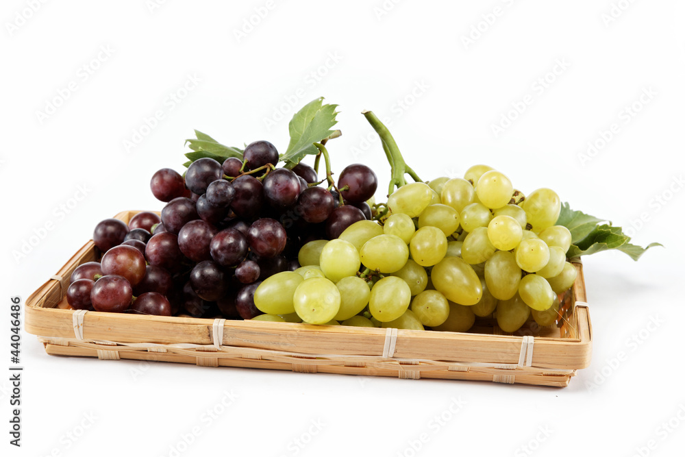 fresh grape fruits with green leaves isolated on white backgroun fresh grape fruits with green leaves isolated on white backgroun