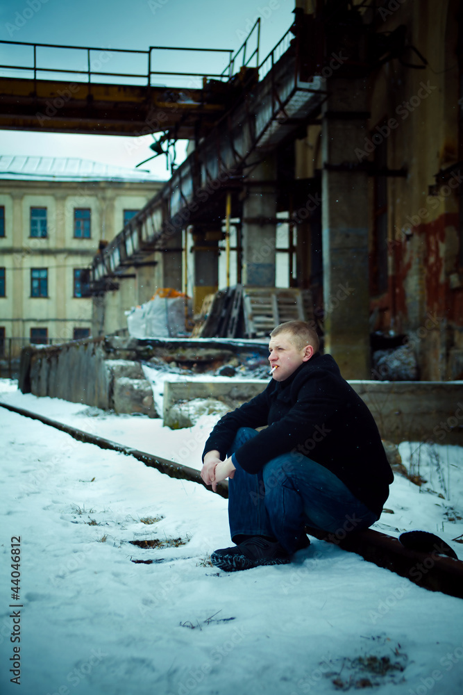 Man in depression sitting on rail