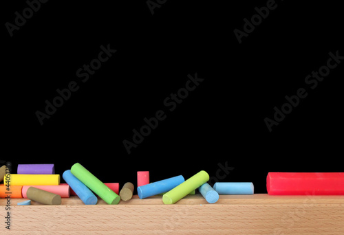 Multicoloured Chalks And A Blackboard