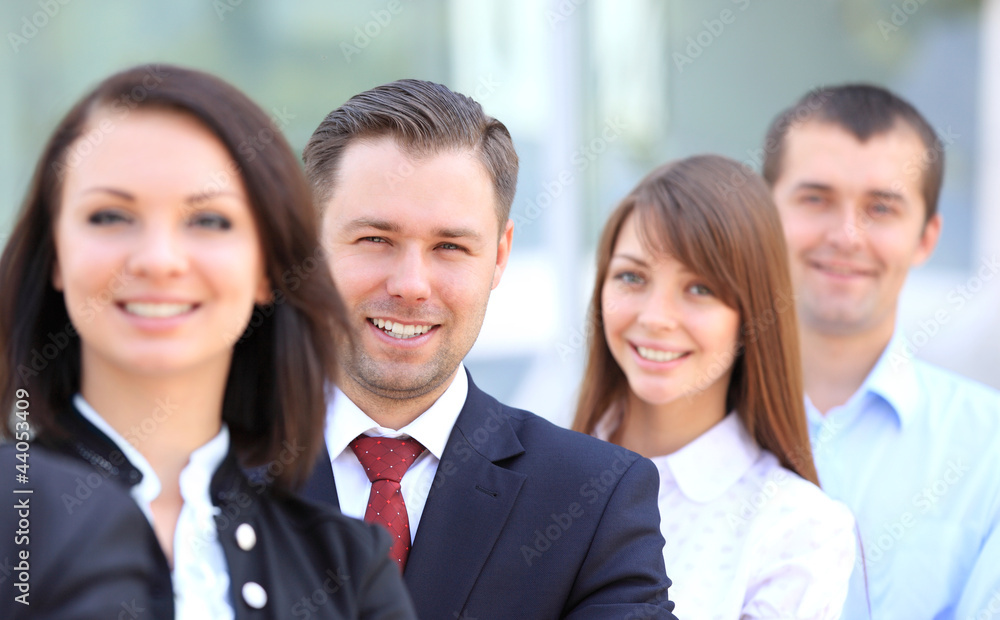 Happy smiling business team standing in a row at office Happy smiling business team standing in a row at office