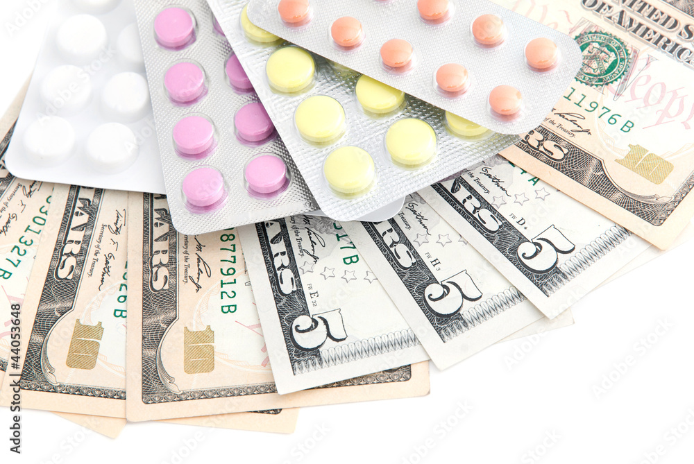 closeup pills and money concept isolated on white background closeup pills and money concept isolated on white background