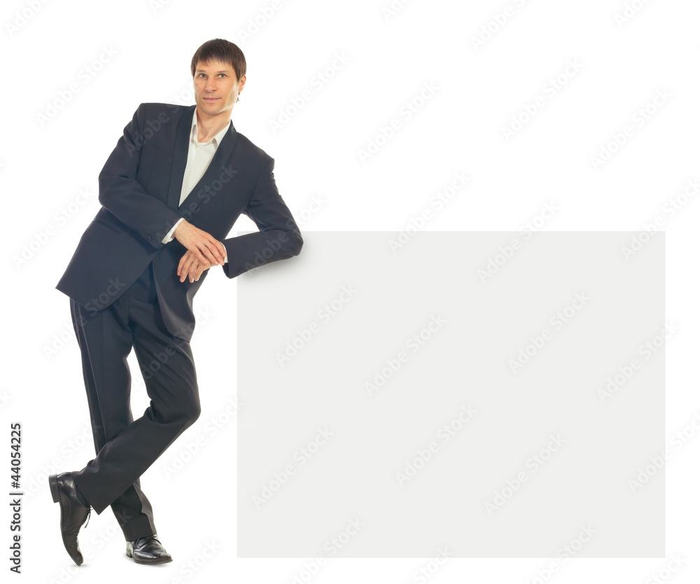 Portrait of young businessman showing blank signboard Portrait of young businessman showing blank signboard