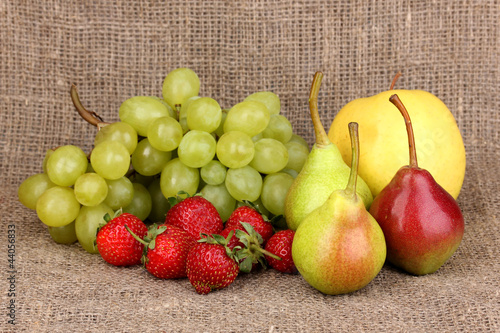 ripe sweet fruits and berries on sackcloth