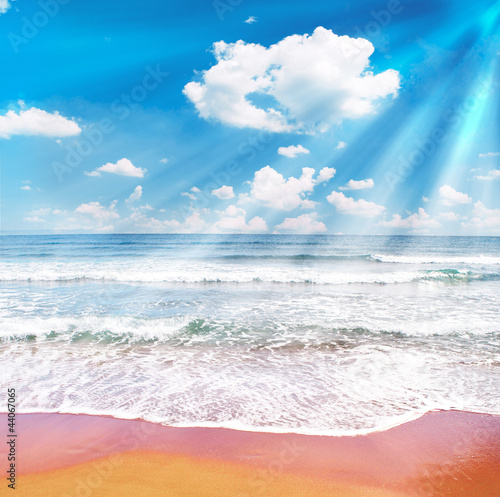 Tropical beach and blue sky with sunrays