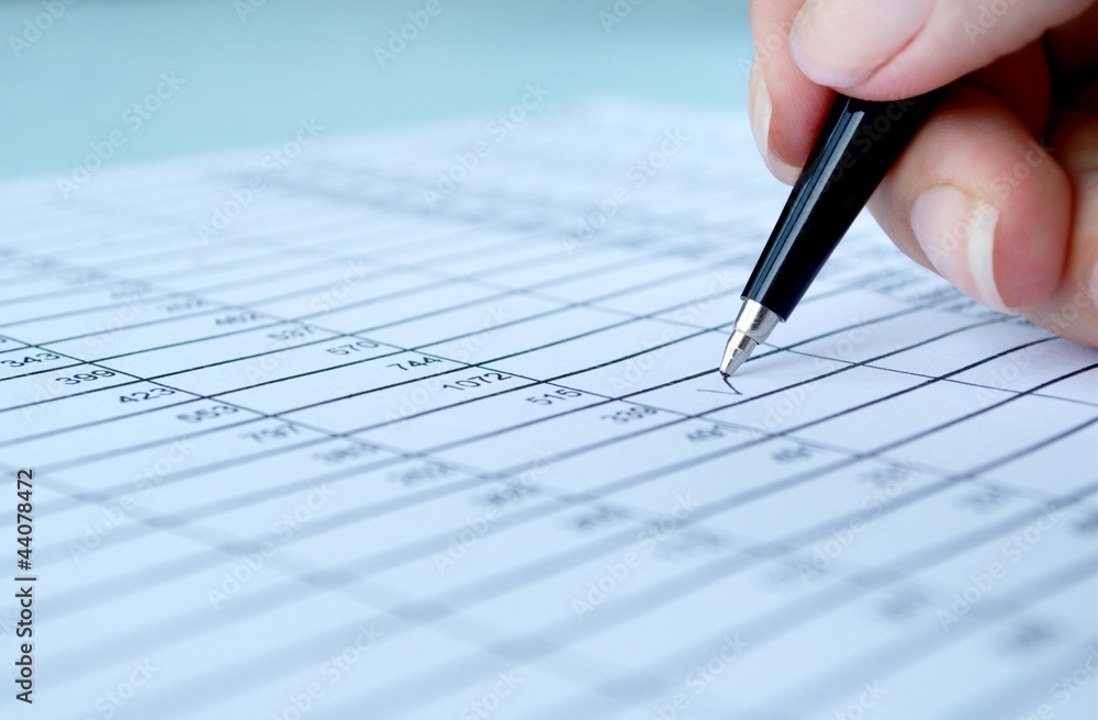 woman's hand writing entries in a notebook woman's hand writing entries in a notebook