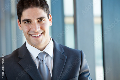 handsome businessman closeup portrait in office © michaeljung