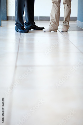 businesspeople standing on office floor