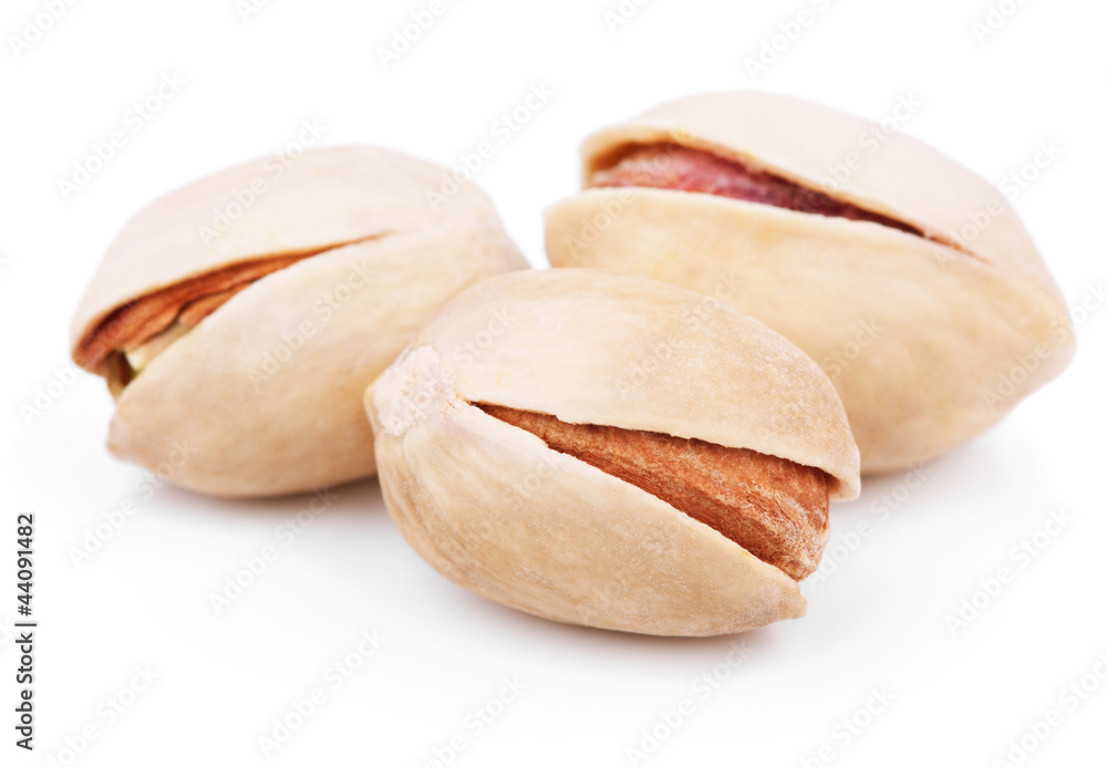 Three pistachio nuts on white Three pistachio nuts on white