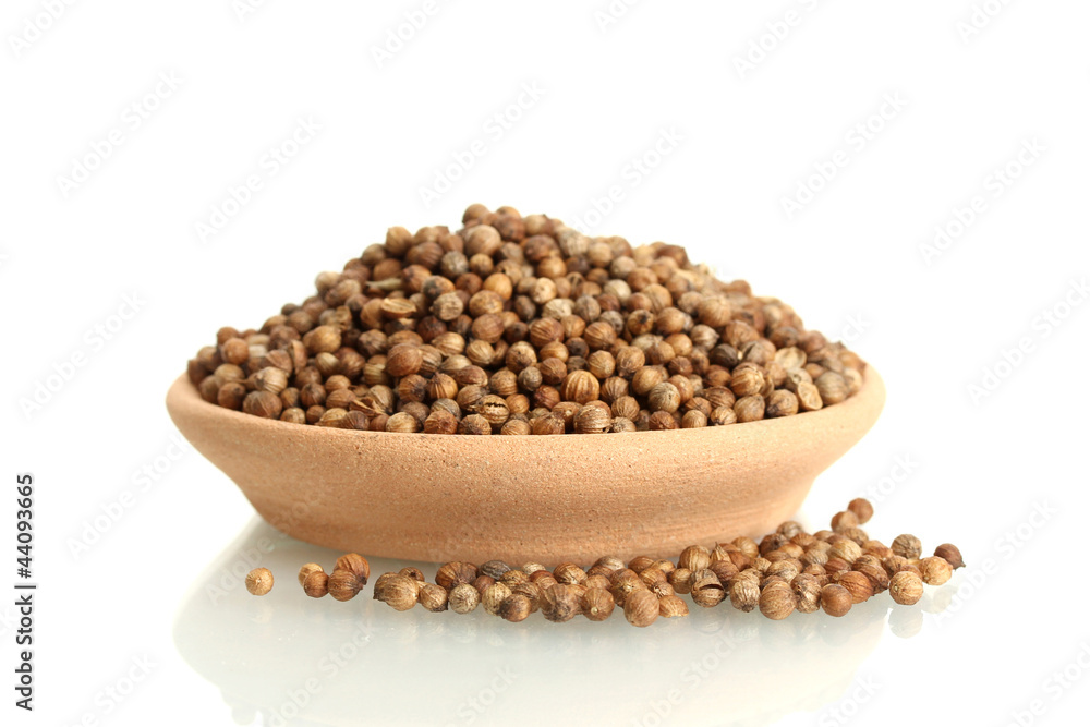 Heap coriander seeds in clay bowl isolated on white Heap coriander seeds in clay bowl isolated on white