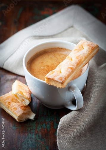 Cup of cafe crema with french pastry