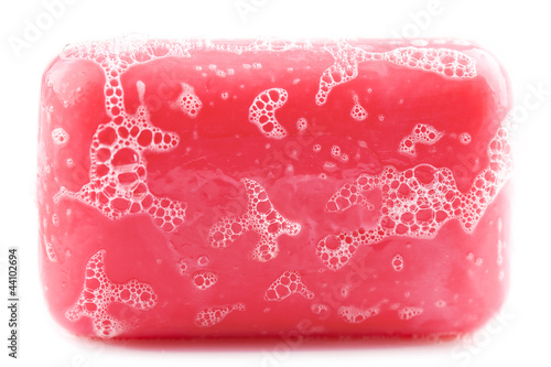Wet bar of pink soap isolated on white background