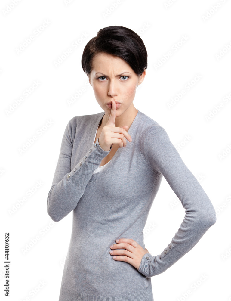 Pretty woman shows shush gesture, isolated on white Pretty woman shows shush gesture, isolated on white