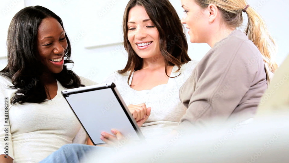Multi ethnic smiling girlfriends have fun on the Internet Multi ethnic smiling girlfriends have fun on the Internet