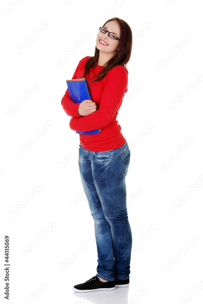 Happy student girl is holding folders and smiling. Happy student girl is holding folders and smiling.