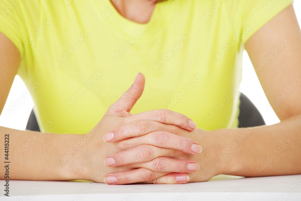 Hands on table with intertwined fingers Stock Photo | Adobe Stock