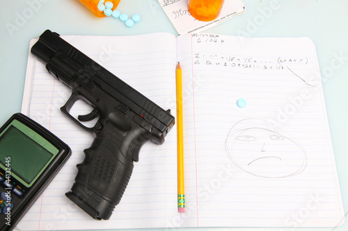 Automatic Pistol, pills, calculator, pencil on composition book