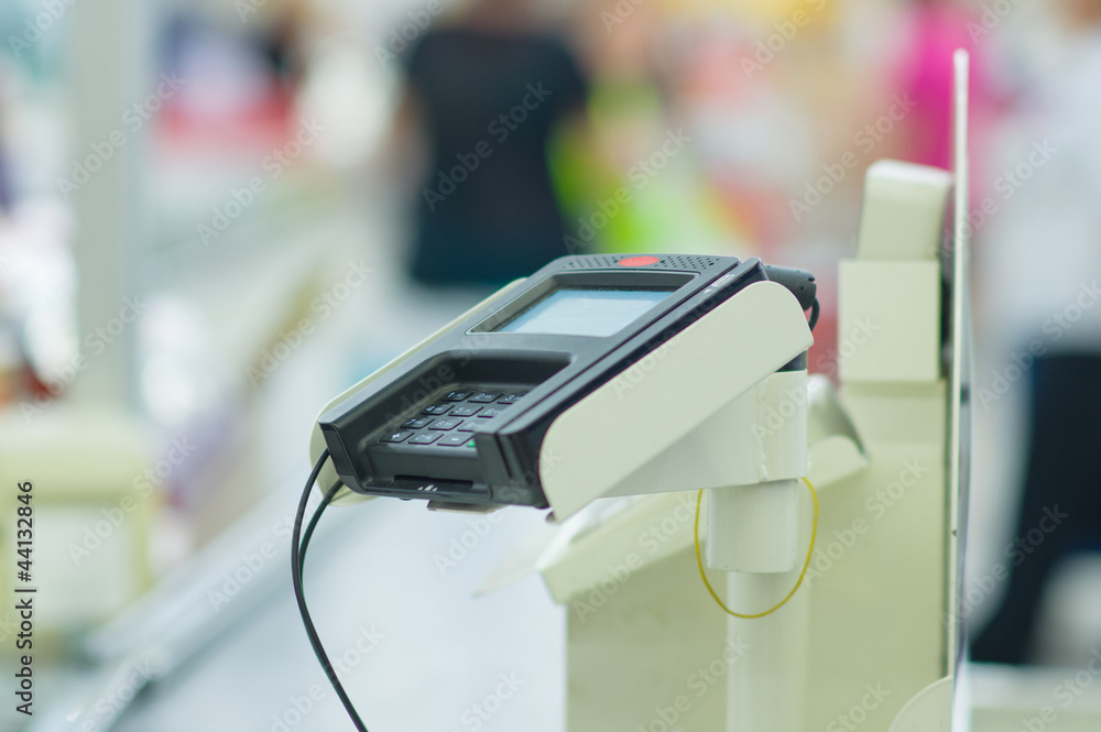 Credit card reader terminal on cash-desk in supermarket Credit card reader terminal on cash-desk in supermarket