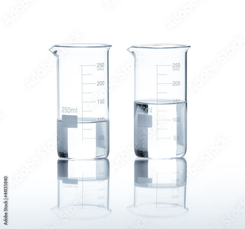 Laboratory flasks with a clear liquid, isolated