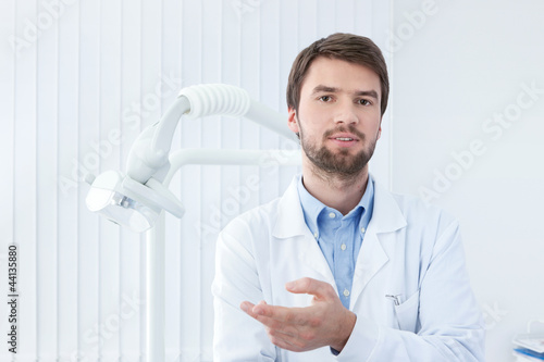 Thoughtful dentist talks to the patient