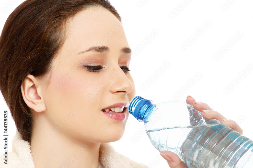 A woman in a sport costume drinking water A woman in a sport costume drinking water