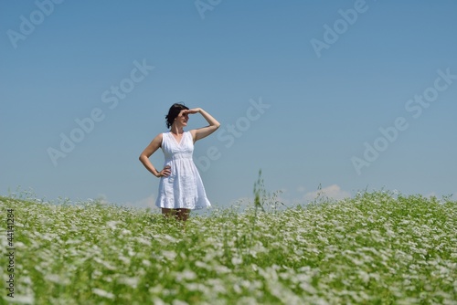 Young happy woman in green field