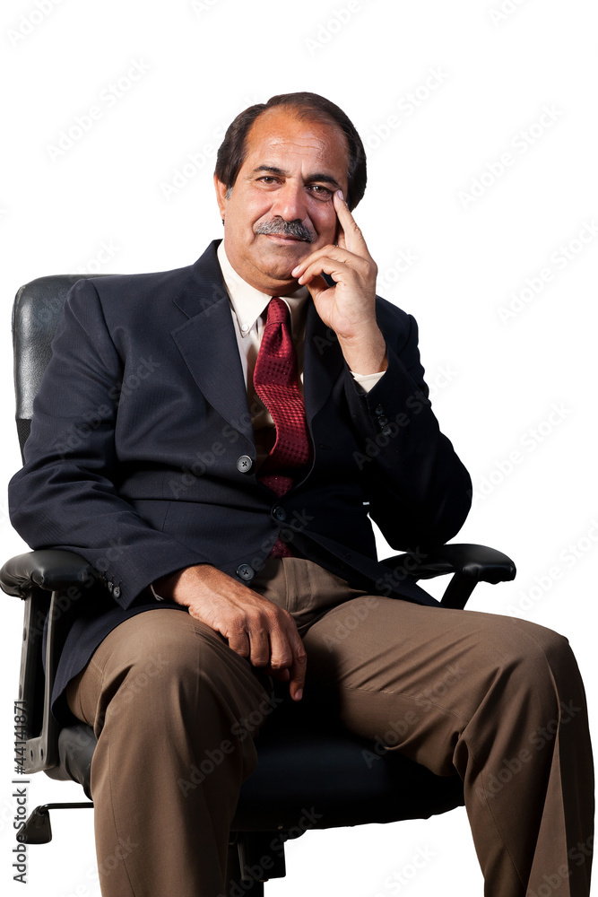 happy, confident senior businessman sitting in the office chair happy, confident senior businessman sitting in the office chair