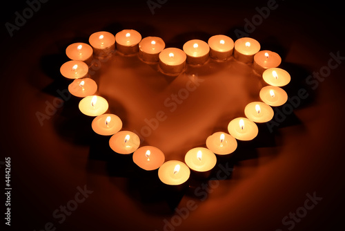 Burning candles in the form of heart