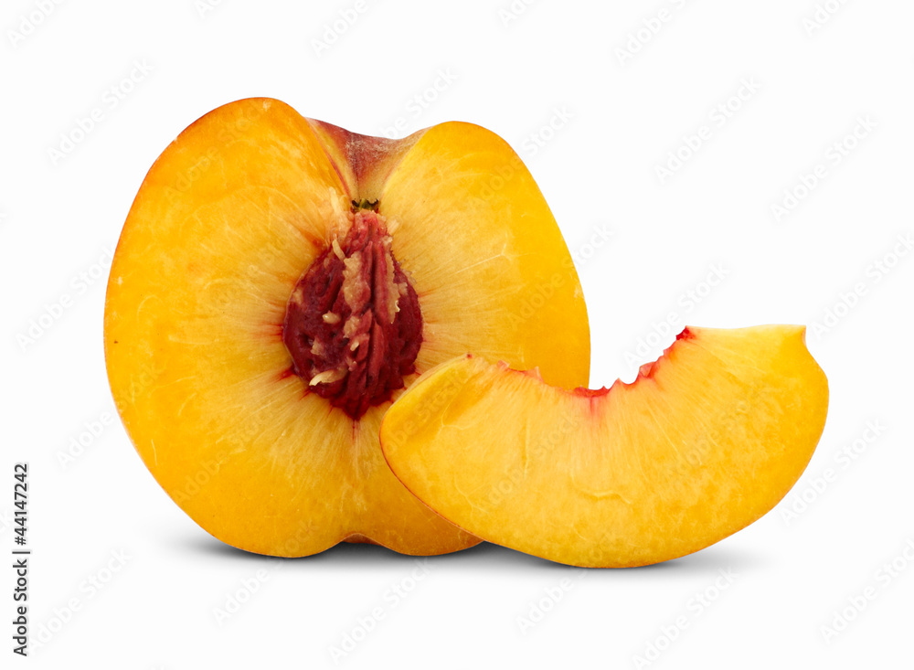 Cut peach with slice on white