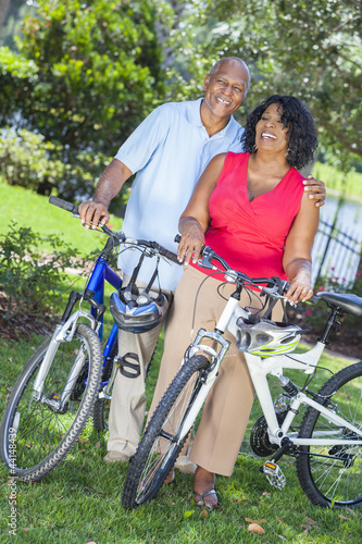 Senior African American Woman & Man Couple Riding Bikes