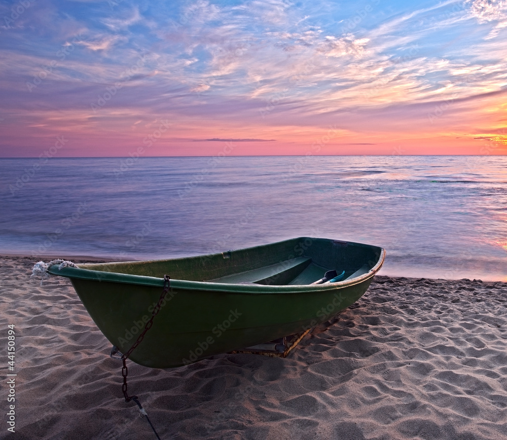 Sunset.Boat on coast.HDR.