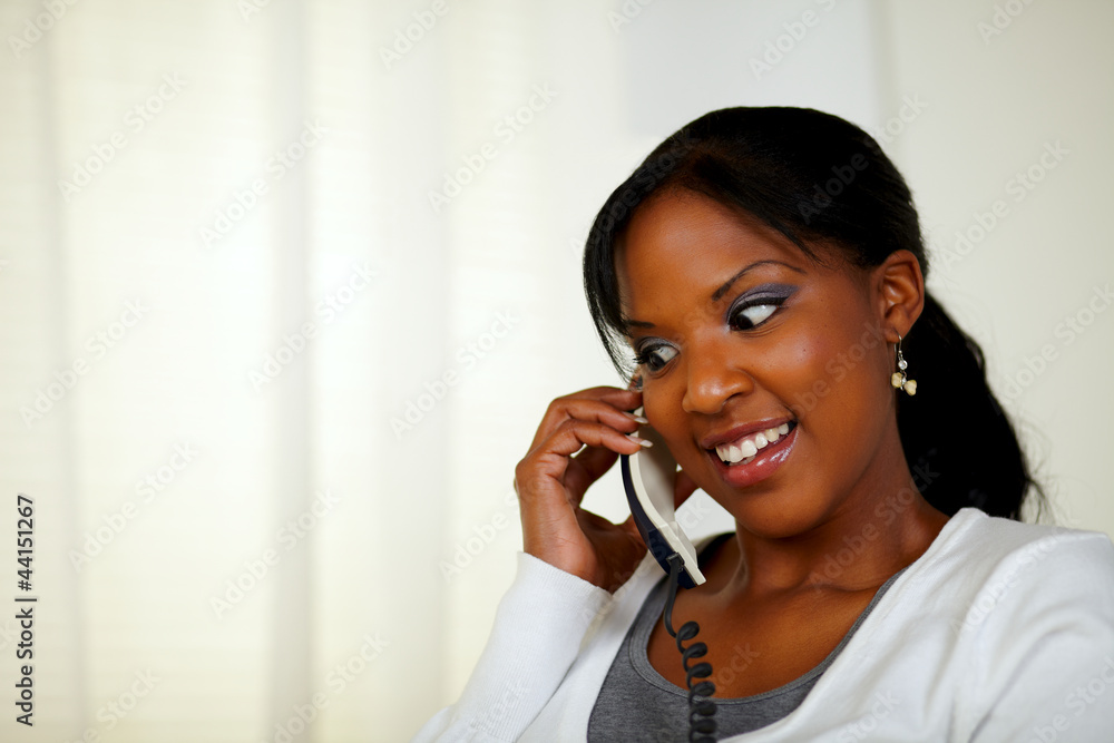 Attractive female smiling and conversing on phone Attractive female smiling and conversing on phone