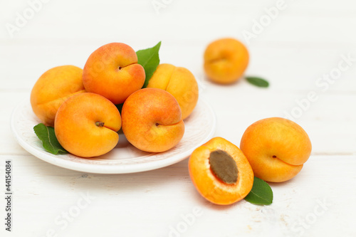 Apricots fruit in the bowl on background