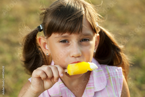 Girl with an appetite for eating ice cream photo