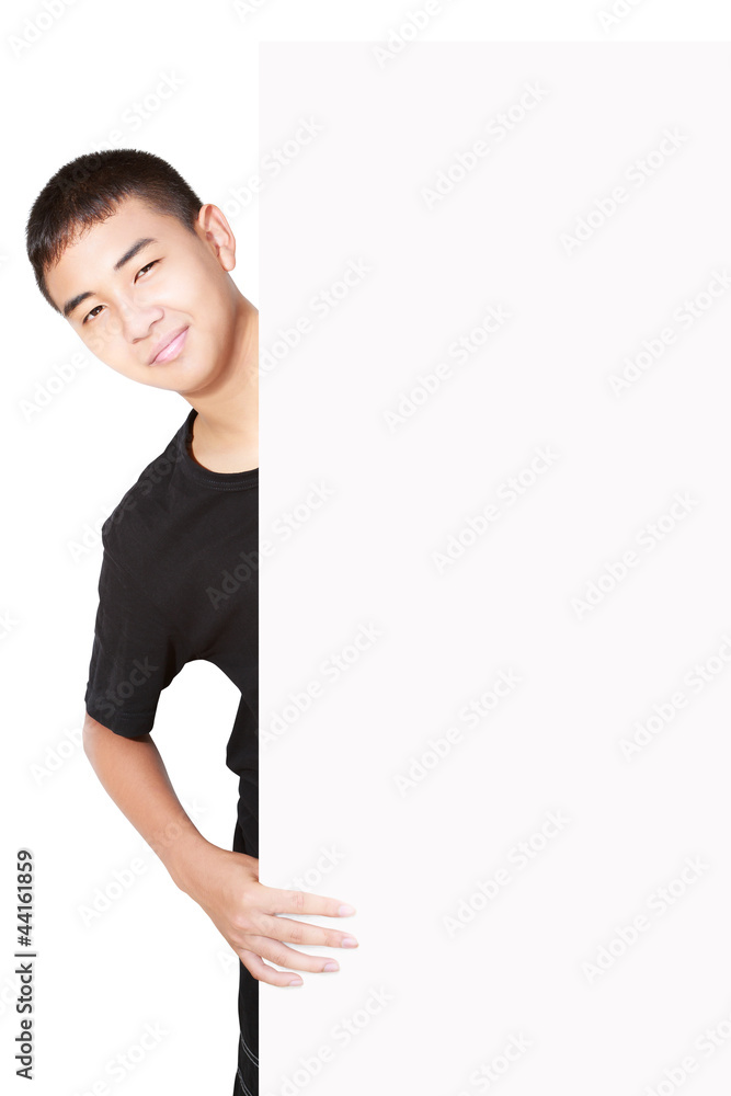 Asian teenager boy behind blank sheet of paper Asian teenager boy behind blank sheet of paper