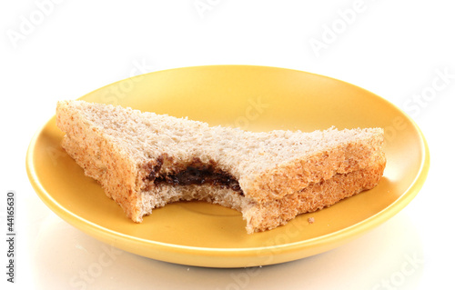 Bitten sandwich with chocolate on plate isolated on white