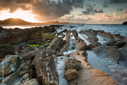 Sunrise ocean landscape Mupe Bay Jurassic Coast England photo