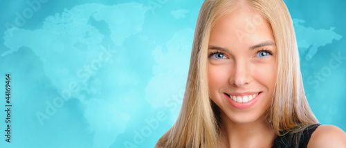 Young beautiful woman standing against worldmap background. Inte photo