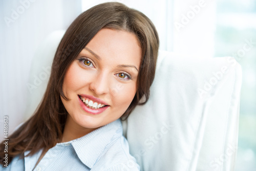 Closeup portrait of cute young business woman smiling while sitt Free Download Closeup portrait of cute young business woman smiling while sitt - GFXLoad