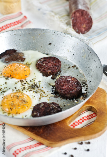 Fried eggs and blood pudding sausage